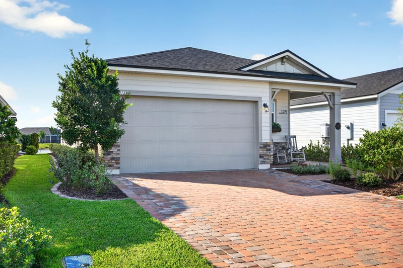 Front exterior with covered porch and driveway at 129 Amberwood Dr, St. Augustine, FL