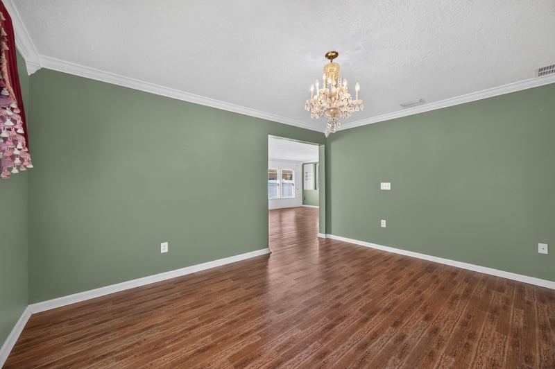 Empty room with chandelier and pass-through to hallway at 2282 Justin Lake Dr, Jacksonville, FL