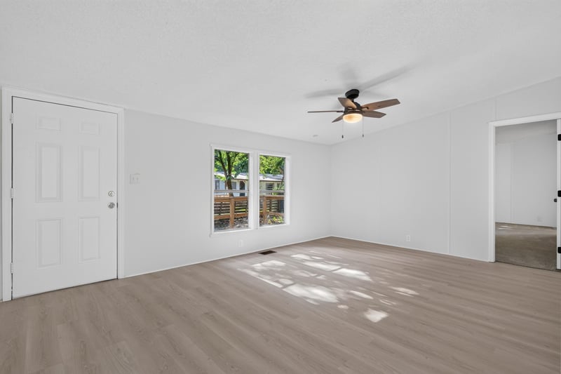 Living room with wood floor and ceiling fan at 55520 Jewel-Thomas Rd, Callahan, FL 32011
