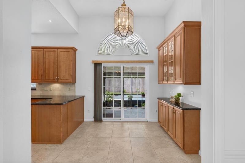 Kitchen with wood cabinets and sliding glass door at 12810 Swamp Owl Ln