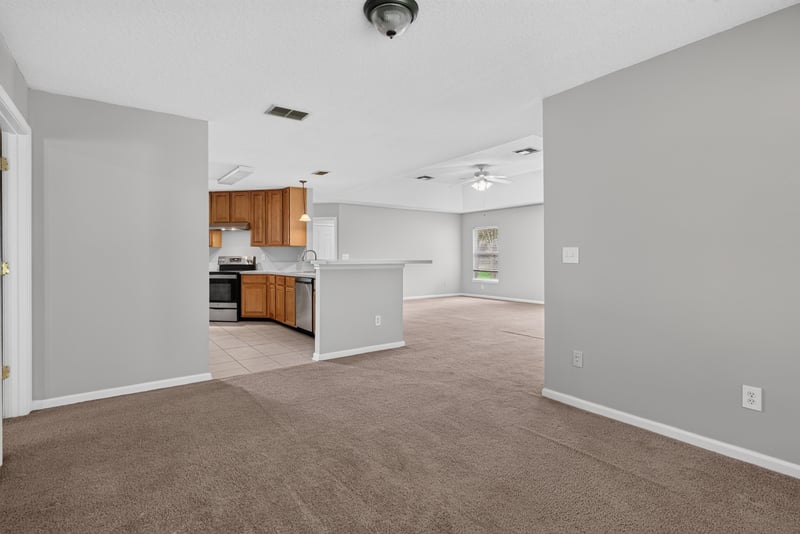 Kitchen view with bar and wood cabinets at 11669 Collins Creek Dr, Jacksonville, FL 32258