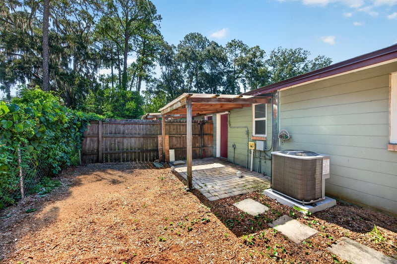 Backyard with fenced perimeter and paver patio at 8067 Parental Cir, Jacksonville, FL 32216