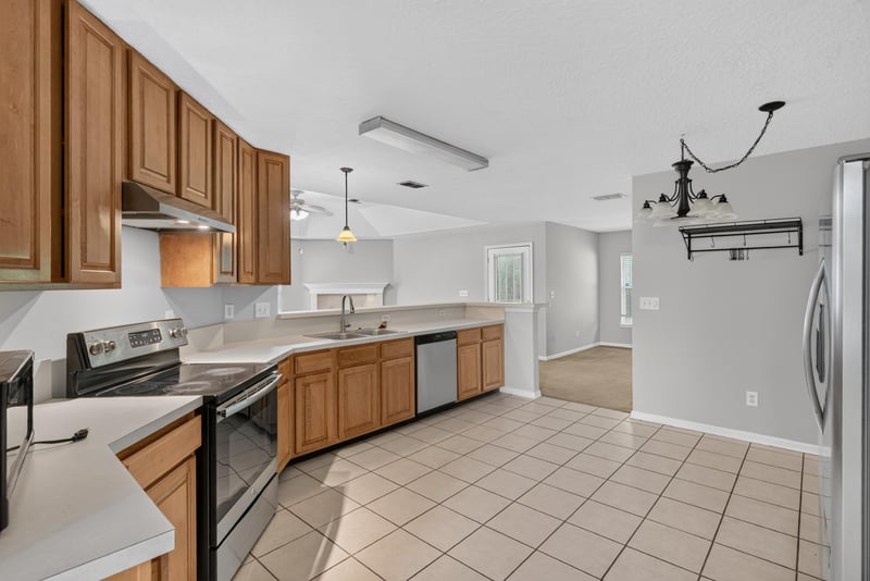 Kitchen with wood cabinets and stainless appliances at 11669 Collins Creek Dr, Jacksonville, FL 32258