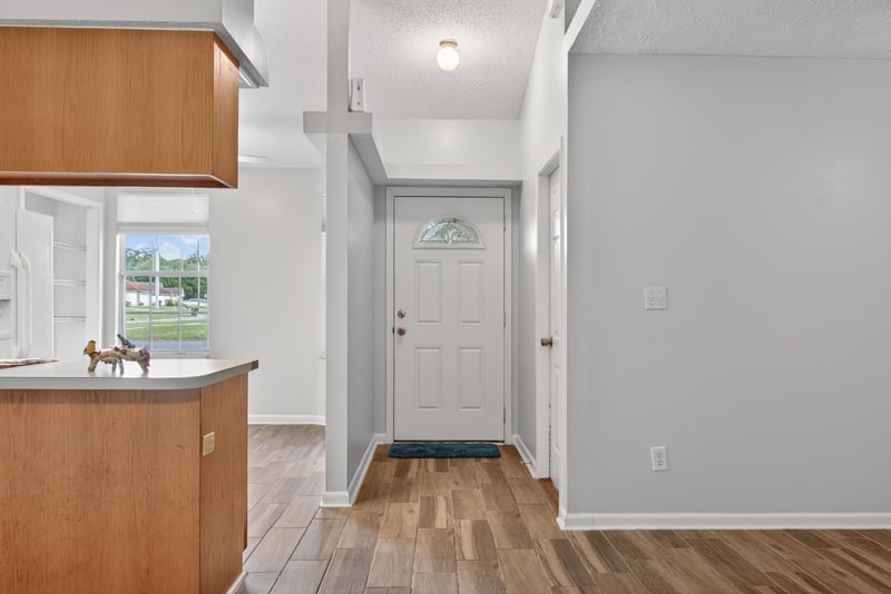 Hallway with kitchen cabinets and front door at 2164 Orangewood St, Middleburg, FL 32068