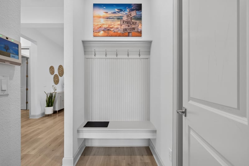 Mudroom bench with hooks near a side entry at 785 Back Creek Dr, St. Augustine, FL 32092