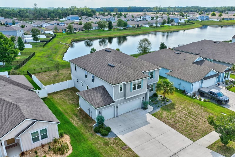 Aerial view of pond and rooftops in surrounding neighborhood in Green Cove Springs, FL