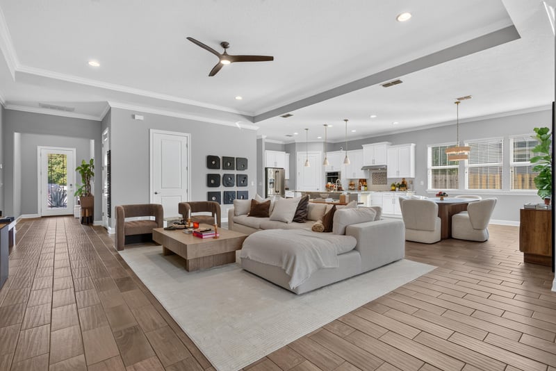 Living room with tray ceiling open to dining area at 3328 Southern Oaks Dr, Green Cove Springs, FL 32043