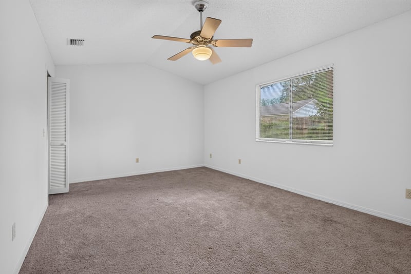Bedroom with ceiling fan and window at 1445 Classic Oak Rd W, Jacksonville, FL
