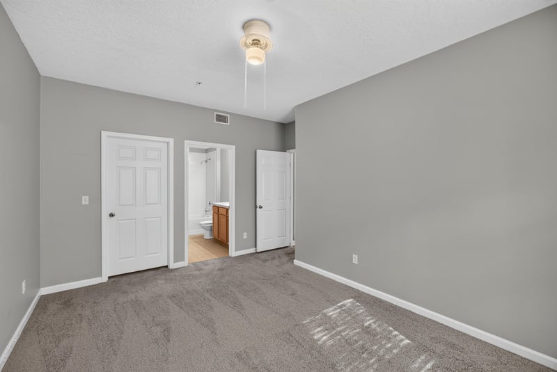 Bedroom with closet doors and carpet at 575 Oakleaf Plantation Pkwy, Orange Park, FL 32065