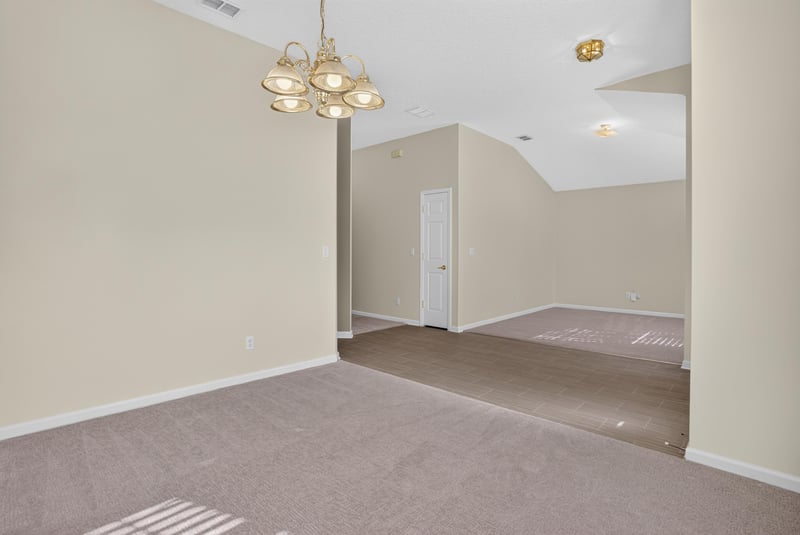 Open living and dining space with carpet at 299 John's Creek Pkwy, St. Augustine, FL 32092