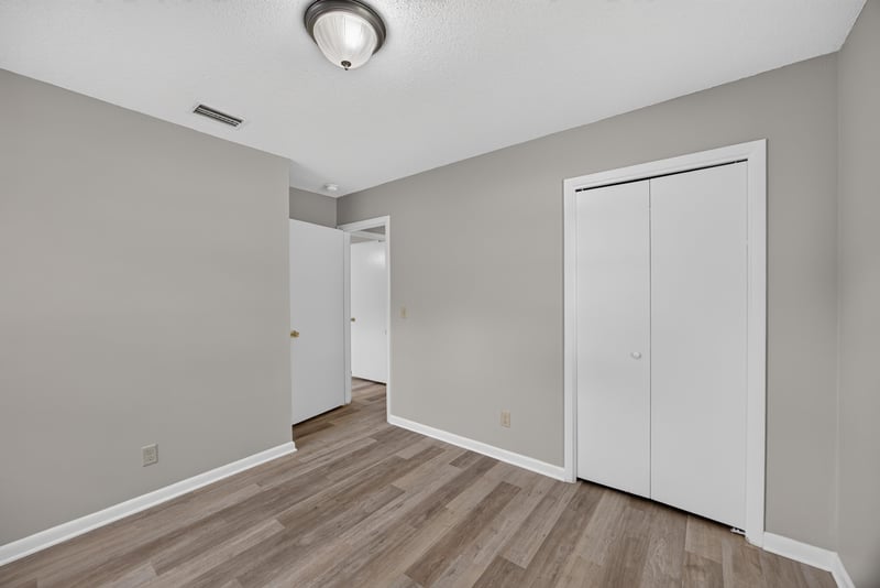 Bedroom with closet door and wood-look flooring at 12351 Condor Dr