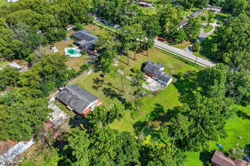 Aerial view of the property and wooded surroundings at 5745 110th St, Jacksonville, FL 32244