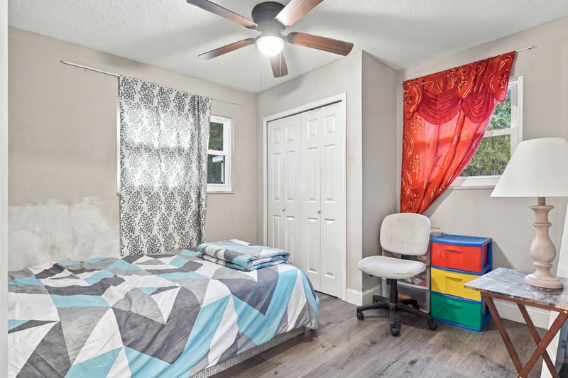 Bedroom with twin bed and red curtain at 357 Dillon Dr, Orange Park, FL