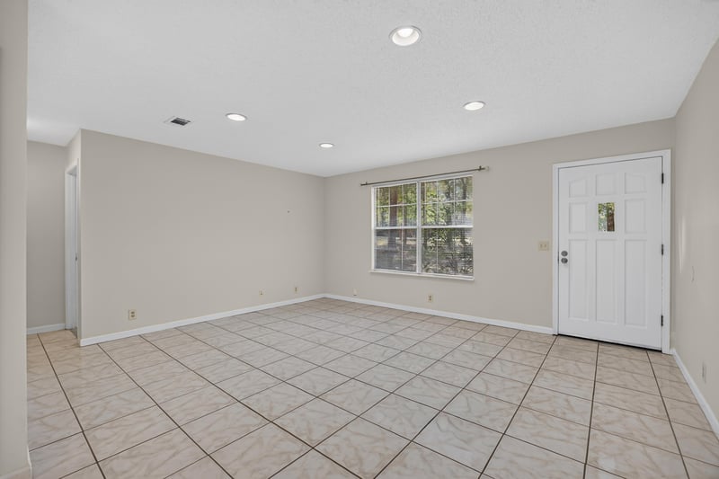Living room with front door and large window at 2829 Blackberry Ave