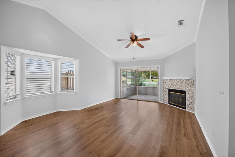 Living room with vaulted ceiling and tile fireplace at 8047 Mactavish Way E, Jacksonville, FL 32244