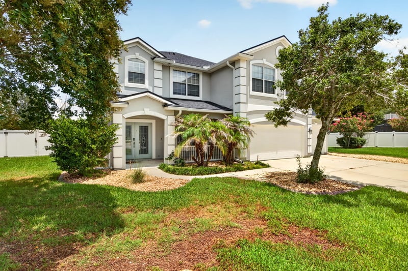 Front exterior with landscaped yard at 1493 Greyfield Dr, St. Augustine, FL 32092
