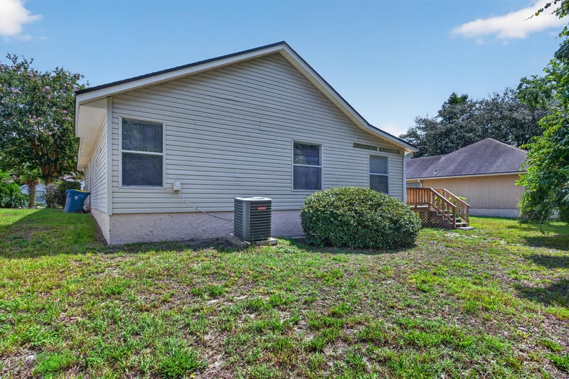 Rear exterior with siding and AC unit at 9256 Dale View Ln W, Jacksonville, FL 32225
