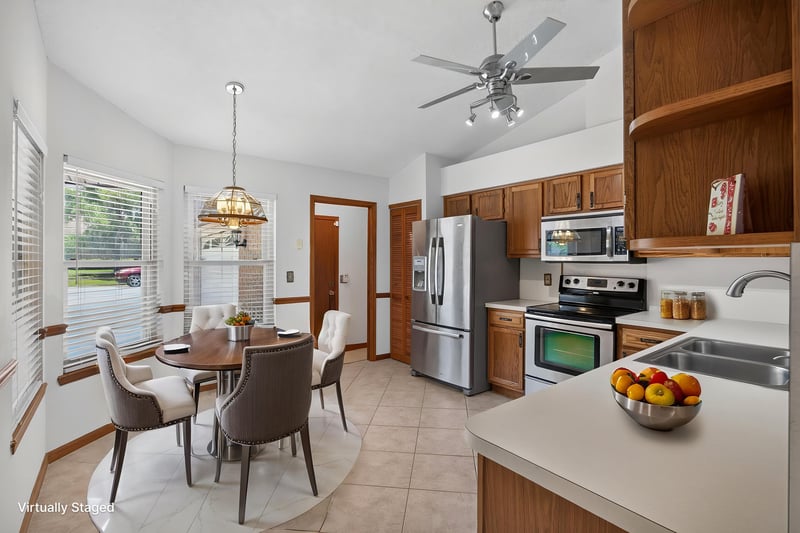 Breakfast nook with dining table and view into kitchen at 2460 San Sago Ln, Jacksonville, FL