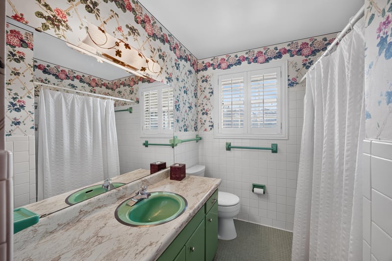 Bathroom with double green sinks and floral wallpaper at 1834 Memory Ln, Jacksonville, FL