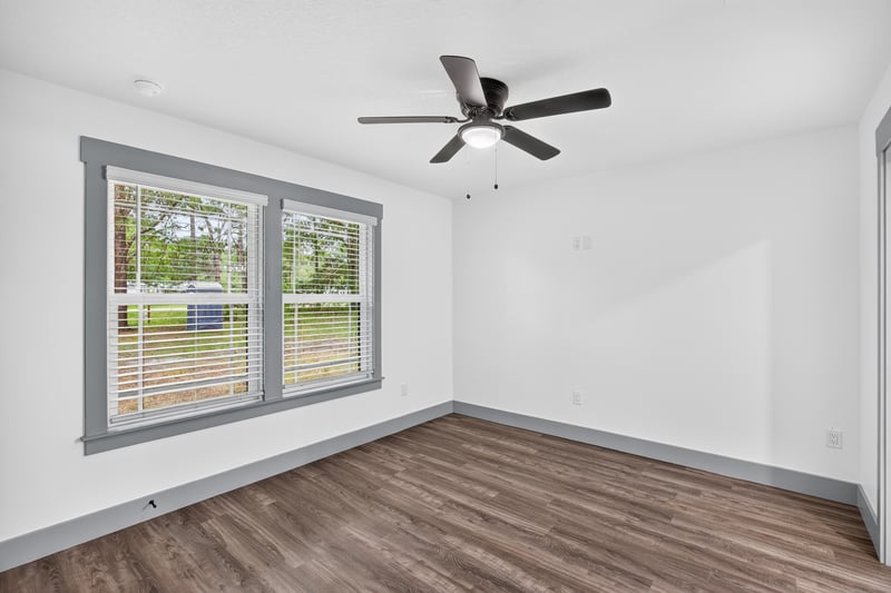 Bedroom staged with bed and windows at 4800 Acacia St, Middleburg, FL 32068
