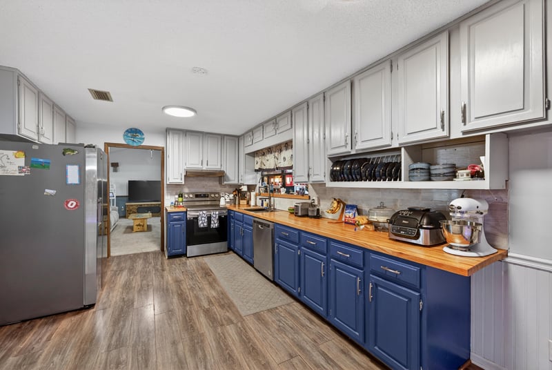 Kitchen with white cabinets and wood countertops at 981 Marble Ridge Dr, Orange Park, FL 32065