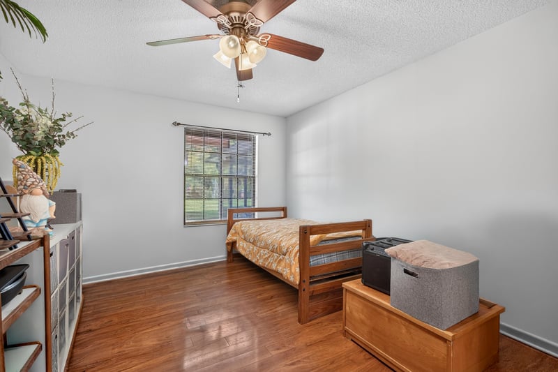 Bedroom with bench seating and window at 2435 Range Line Rd, Middleburg, FL