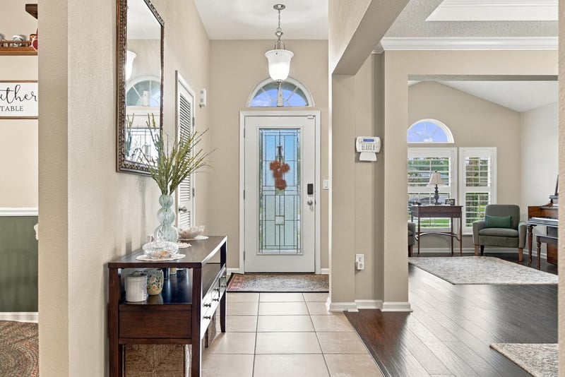 Foyer with glass front door and chandelier at 10923 Black Diamond Ct, Jacksonville, FL