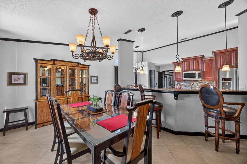 Dining table with chairs and kitchen bar at 6931 Cane Grass Ln E, Jacksonville, FL 32244