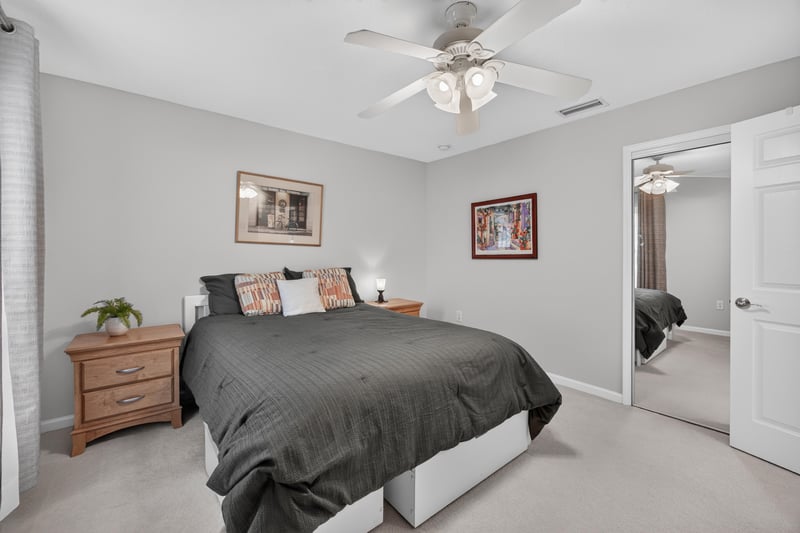 Secondary bedroom with mirrored closet doors at 11225 Water Spring Cir, Jacksonville, FL 32256
