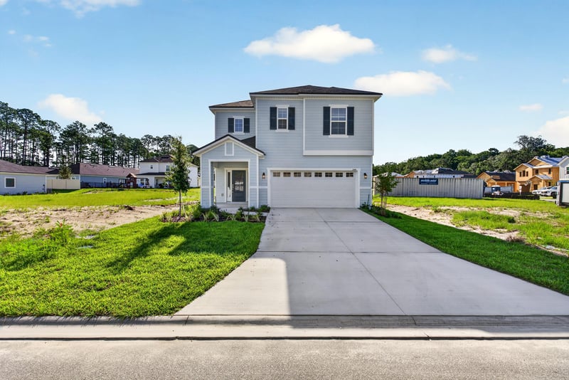 Front exterior view with covered entry and green lawn at 269 Bluegrass Wy, St. Augustine, FL 32092