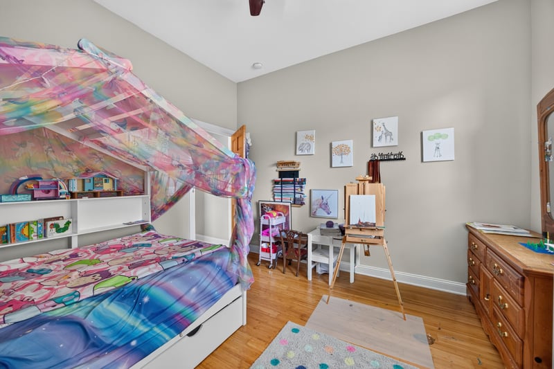 Bedroom with canopy bed and wall art at 1735 Hagans Ridge Ct
