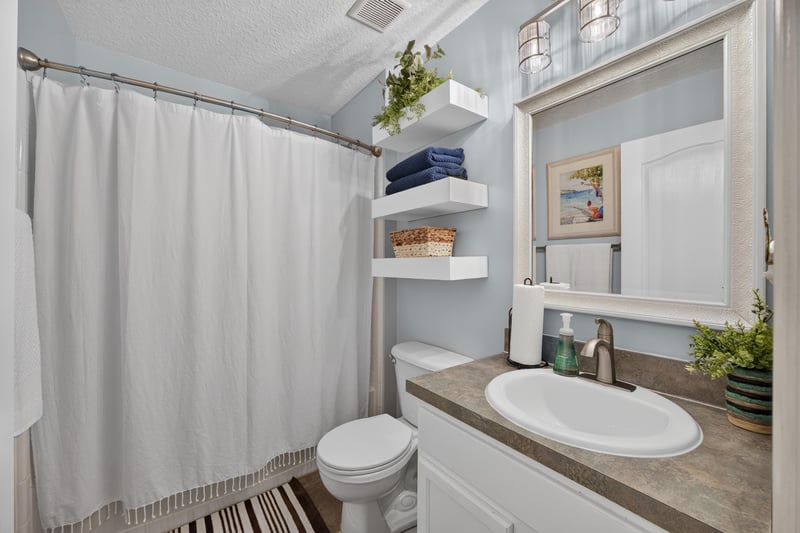 Bathroom with vanity and shower curtain at 1589 Backwater Drive, Middleburg, FL 32068