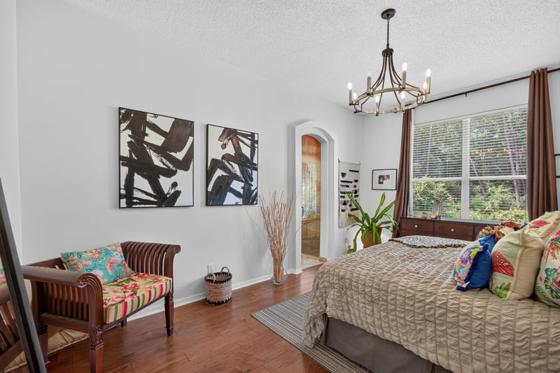 Bedroom with colorful bedding and arched doorway at 1820 Burgess Hill Dr E, Jacksonville, FL