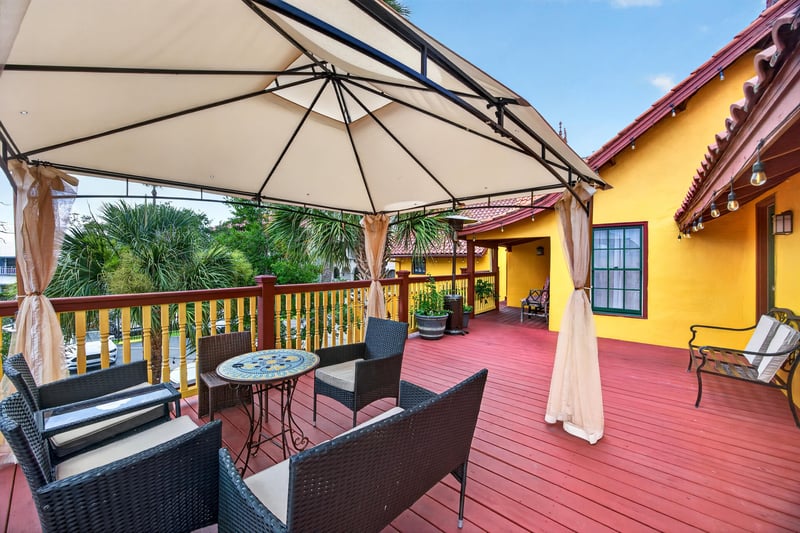 Deck with an umbrella table overlooking the courtyard at 115 Cordova St, St. Augustine, FL