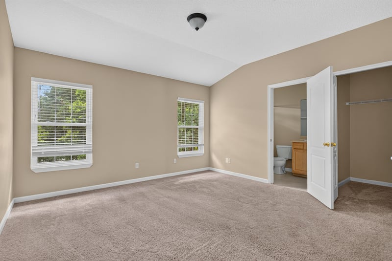 Bedroom with two doors and carpet at 12359 Mangrove Forest Ct, Jacksonville, FL 32218