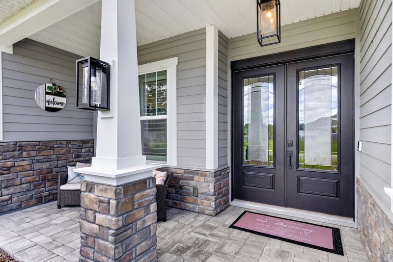 Front porch detail with stone columns and seating at 785 Back Creek Dr, St. Augustine, FL 32092