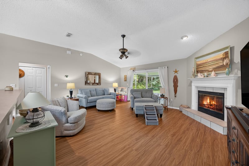 Living room with stone fireplace and sectional sofa at 13514 Las Brisas Way N, Jacksonville, FL