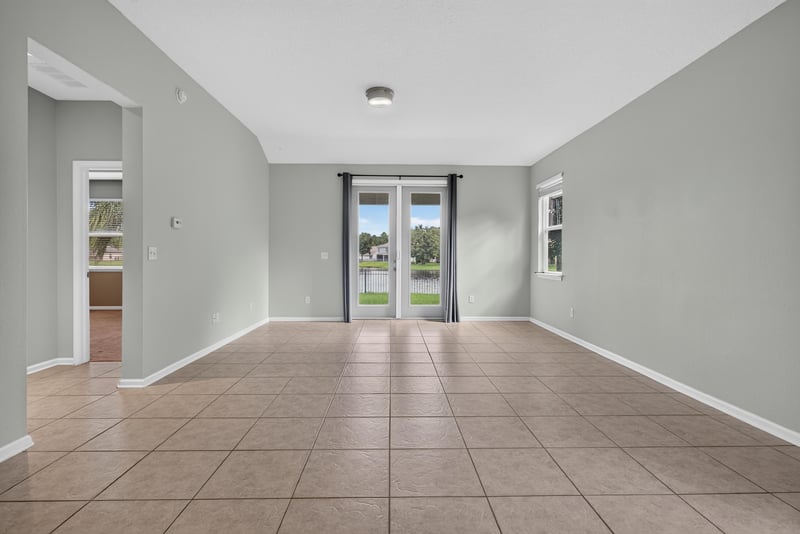 Living room with sliding glass doors to backyard at 13685 Goodson Pl, Jacksonville, FL 32226