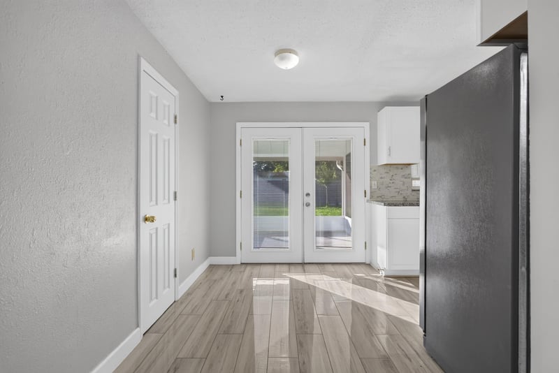 Hallway with French doors and dark flooring at 442 Ameca Ave, Orange Park, FL 32073