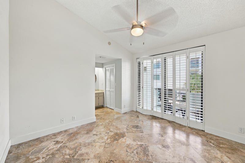 Empty bedroom with shuttered doors and carpet at 752 Spinnakers Reach Dr, Ponte Vedra Beach, FL 32082