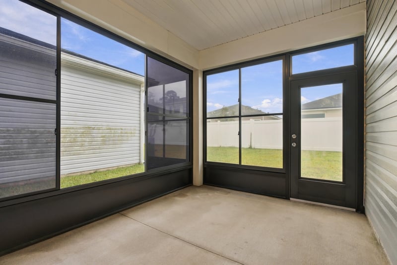 Screened porch with patio table and chairs at 7088 Mahogany Run Dr, Jacksonville, FL 32244