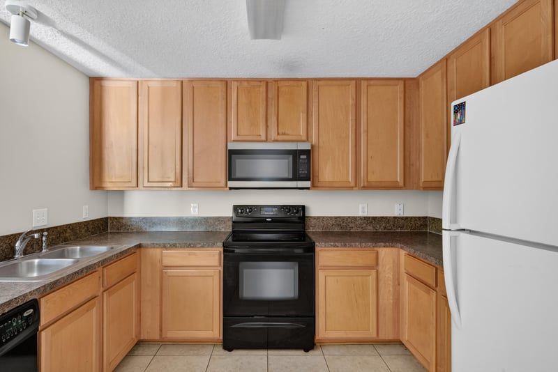 Kitchen with black range and microwave at 7047 Deer Lodge Cir, Jacksonville