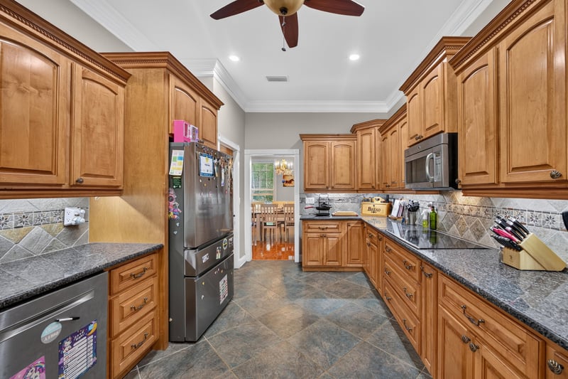 Kitchen with refrigerator and granite counters at 1735 Hagans Ridge Ct