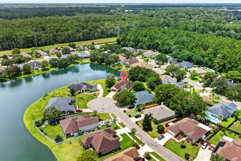 Aerial view of a lake winding through the neighborhood in Windsor Chase