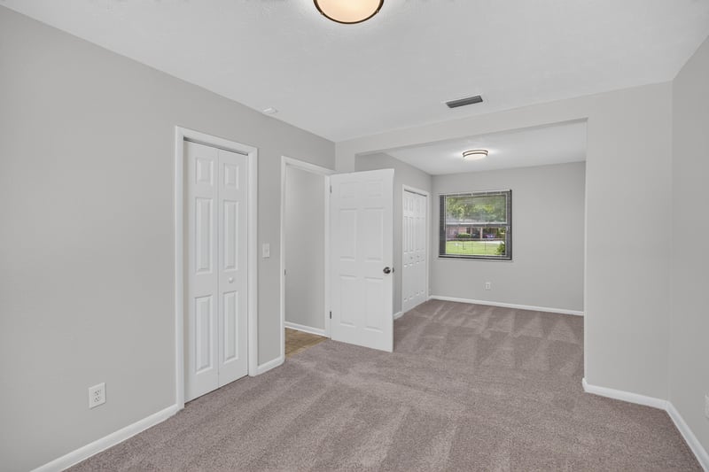 Empty bedroom with double closet doors at 7453 Jade Dr N, Jacksonville, FL 32210