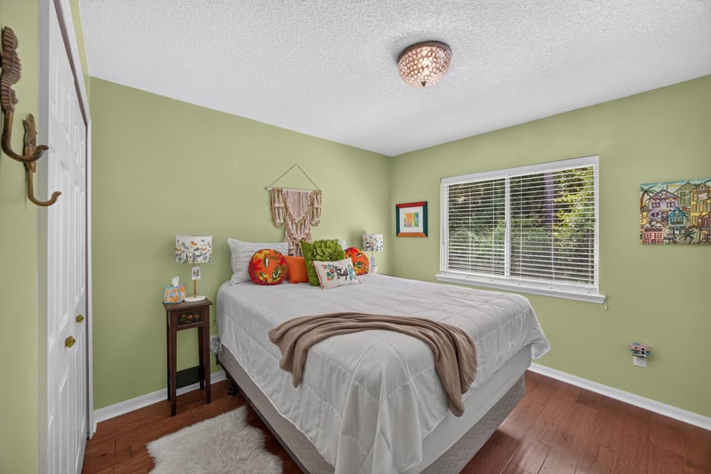 Bedroom with green walls and window at 1820 Burgess Hill Dr E, Jacksonville, FL