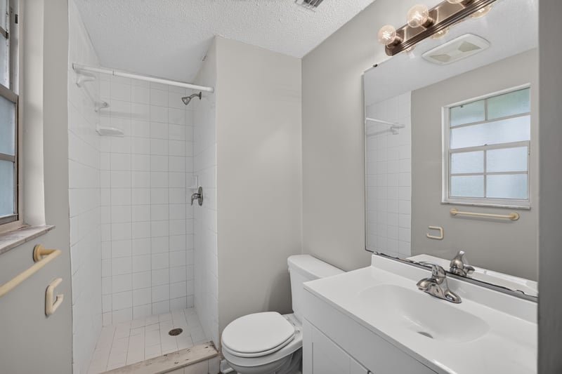 Bathroom with shower, mirror, and window at 1435 Undine Ave, Jacksonville, FL