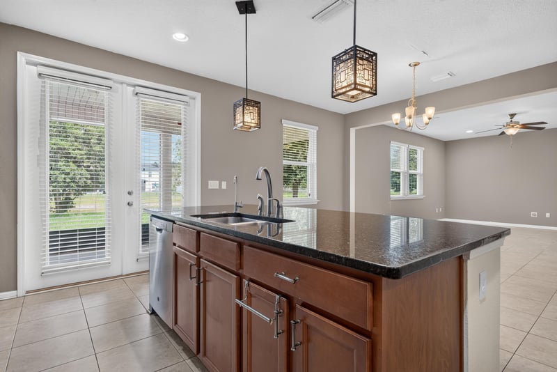 Kitchen with granite island, pendant lights and French doors at 263 Gilmore Ln, Orange Park, FL 32065