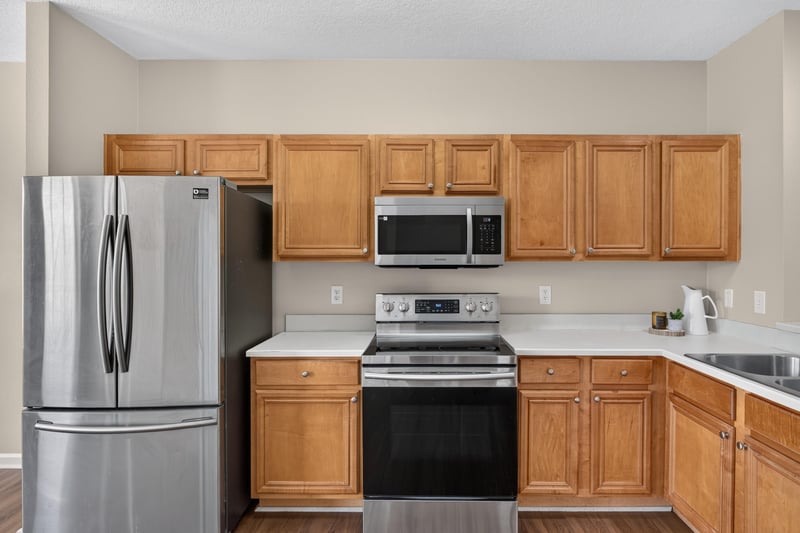 Kitchen cabinetry with stainless refrigerator and range at 3750 Silver Bluff Blvd, Orange Park, FL
